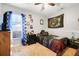 Cozy bedroom with gaming theme, ceiling fan, and natural light at 1311 Rain Forest Ln, Minneola, FL 34715