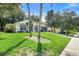 Well-maintained home with lush green lawn and mature trees at 1311 Rain Forest Ln, Minneola, FL 34715