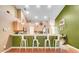 Bright eat-in kitchen with stainless steel appliances and seating for four at the breakfast bar at 1311 Rain Forest Ln, Minneola, FL 34715