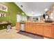 Modern kitchen features stainless steel dishwasher and ample counter space at 1311 Rain Forest Ln, Minneola, FL 34715