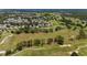 An aerial view of a vast, green golf course adjacent to a residential community, perfect for recreation at 13165 Se 93Rd Cir, Summerfield, FL 34491
