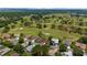 This aerial view features the community golf course with mature trees and meticulously maintained greens at 13165 Se 93Rd Cir, Summerfield, FL 34491