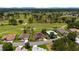 This aerial shot displays a home nestled among others on a street adjacent to the golf course at 13165 Se 93Rd Cir, Summerfield, FL 34491