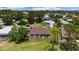 A beautiful backyard with an enclosed patio, well maintained lawn, and mature trees at 13165 Se 93Rd Cir, Summerfield, FL 34491