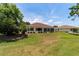 The screened-in lanai on the back of the home overlooks a large, well maintained lawn at 13165 Se 93Rd Cir, Summerfield, FL 34491