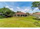 The screened-in lanai on the back of the home overlooks a large, well maintained lawn at 13165 Se 93Rd Cir, Summerfield, FL 34491