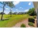 Scenic backyard with a view of the golf course and lush landscaping in a bright setting at 13165 Se 93Rd Cir, Summerfield, FL 34491