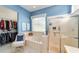 Bright bathroom features a soaking tub, a walk-in shower, and a spacious walk-in closet at 13165 Se 93Rd Cir, Summerfield, FL 34491