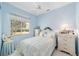 Serene bedroom features a comfortable bed, soft lighting and a tranquil window view at 13165 Se 93Rd Cir, Summerfield, FL 34491