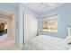 Light and airy bedroom featuring a cozy bed and a bright window with tranquil view at 13165 Se 93Rd Cir, Summerfield, FL 34491