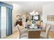 Charming dining area featuring a glass table, chandelier, and elegant decor at 13165 Se 93Rd Cir, Summerfield, FL 34491