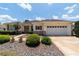 Lovely single-story home features a well-manicured lawn, lovely landscaping, and a two-car garage at 13165 Se 93Rd Cir, Summerfield, FL 34491