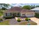 Well-maintained lawn and shrubs accent this home with an attached two car garage and paver driveway at 13165 Se 93Rd Cir, Summerfield, FL 34491