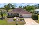 Well-maintained lawn and shrubs accent this home with an attached two car garage and paver driveway at 13165 Se 93Rd Cir, Summerfield, FL 34491