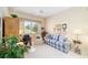 Bright home office with vaulted ceiling, view of exterior and cozy blue plaid sofa at 13165 Se 93Rd Cir, Summerfield, FL 34491