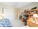 Home office featuring ample closet space, desk, and wooden shelving unit at 13165 Se 93Rd Cir, Summerfield, FL 34491