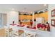 Well-lit kitchen featuring wood cabinets, white countertops, and bar stool seating at 13165 Se 93Rd Cir, Summerfield, FL 34491