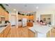 Bright kitchen with wood cabinets, white appliances, and an eat-in bar area at 13165 Se 93Rd Cir, Summerfield, FL 34491