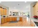 Open concept kitchen featuring wood cabinets and a view into the living area at 13165 Se 93Rd Cir, Summerfield, FL 34491