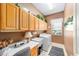 Convenient laundry room with abundant counter and cabinet space plus large utility sink at 13165 Se 93Rd Cir, Summerfield, FL 34491