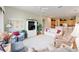 Comfortable living room with ample seating and an open view to the kitchen at 13165 Se 93Rd Cir, Summerfield, FL 34491