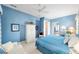 Bright, airy main bedroom boasts soothing blue walls, soft carpet and a relaxing seating area at 13165 Se 93Rd Cir, Summerfield, FL 34491