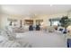 Expansive sunroom with multiple seating areas and large windows overlooking the garden at 13165 Se 93Rd Cir, Summerfield, FL 34491