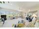 Bright sunroom with multiple seating areas and scenic views of the surrounding landscape at 13165 Se 93Rd Cir, Summerfield, FL 34491
