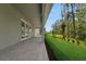 Paver patio overlooks a grassy backyard with mature trees, extending from the home's covered lanai at 14249 Crest Palm Ave, Windermere, FL 34786