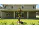A lush green backyard with manicured lawn and view of the home's covered patio; ideal for outdoor enjoyment at 14249 Crest Palm Ave, Windermere, FL 34786