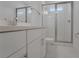 An elegant bathroom has white cabinets, brushed nickel hardware, and a glass-enclosed shower for a luxurious feel at 14249 Crest Palm Ave, Windermere, FL 34786
