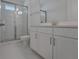 Modern bathroom with glass shower, bright vanity and white marble floors, offering a clean aesthetic at 14249 Crest Palm Ave, Windermere, FL 34786