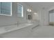 Elegant bathroom with a freestanding tub, dual vanities, and large windows for plenty of natural light at 14249 Crest Palm Ave, Windermere, FL 34786