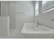 Bright bathroom with a freestanding tub, glass-enclosed shower, and modern fixtures at 14249 Crest Palm Ave, Windermere, FL 34786
