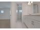 Bright bathroom featuring a double vanity and a glass-enclosed shower, offering a modern and clean aesthetic at 14249 Crest Palm Ave, Windermere, FL 34786