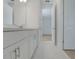 Bathroom with new tile, white cabinets, and view to bedroom at 14249 Crest Palm Ave, Windermere, FL 34786