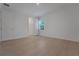 A well-lit bedroom boasts light-colored wood flooring, white walls, and double doors to a closet at 14249 Crest Palm Ave, Windermere, FL 34786