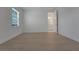 Well-lit bedroom with light wood flooring, a window with blinds, and an ensuite bathroom at 14249 Crest Palm Ave, Windermere, FL 34786