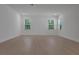 Bright bedroom with wood-look floors and a view of lush greenery at 14249 Crest Palm Ave, Windermere, FL 34786