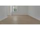 Bright bedroom with wood-look floors and a large window at 14249 Crest Palm Ave, Windermere, FL 34786