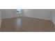 Spacious bedroom featuring wood floors and a bright window providing natural light at 14249 Crest Palm Ave, Windermere, FL 34786
