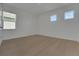 Bedroom featuring two windows and light wood flooring, providing a bright and airy atmosphere at 14249 Crest Palm Ave, Windermere, FL 34786