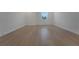 Bedroom with light wood flooring and large window offering a view with lots of natural light at 14249 Crest Palm Ave, Windermere, FL 34786