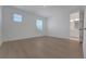 Bedroom with light wood floors and natural light showcasing a view to the ensuite bathroom at 14249 Crest Palm Ave, Windermere, FL 34786