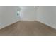 Empty bedroom with hardwood floors, base molding and a large window for natural light at 14249 Crest Palm Ave, Windermere, FL 34786