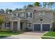 Charming two-story home featuring a three-car garage and well-manicured landscaping at 14249 Crest Palm Ave, Windermere, FL 34786