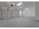 Spacious three-car garage with epoxy flooring providing ample parking and storage space at 14249 Crest Palm Ave, Windermere, FL 34786