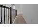 Bright hallway with wood-look floors and decorative wrought iron railing at 14249 Crest Palm Ave, Windermere, FL 34786