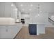 Modern kitchen with stainless steel appliances, white cabinets, and a large center island at 14249 Crest Palm Ave, Windermere, FL 34786