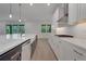 Modern kitchen with stainless steel appliances, white cabinets, and a large center island at 14249 Crest Palm Ave, Windermere, FL 34786